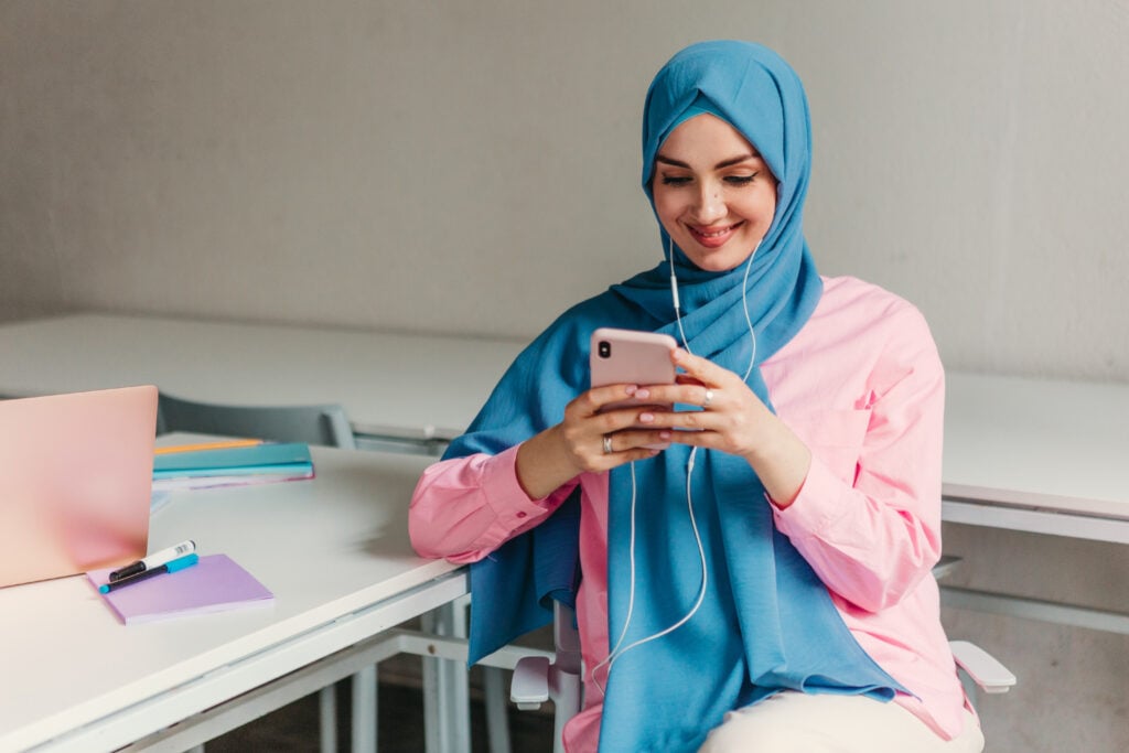 Arabic woman studying on her phone