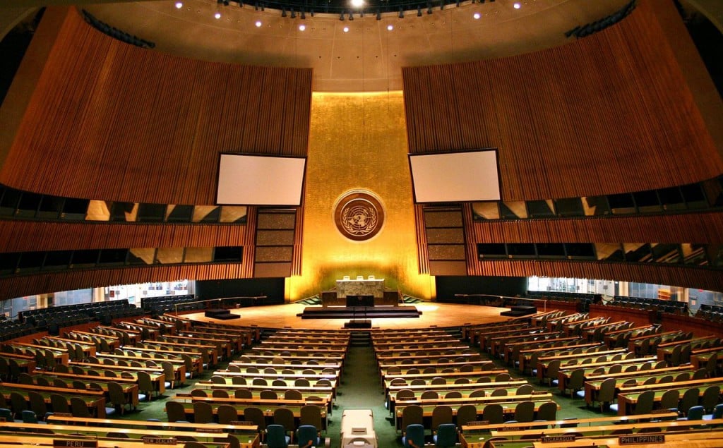 "UN General Assembly hall" by Patrick Gruban, cropped and downsampled by Pine - originally posted to Flickr as UN General Assembly. Licensed under CC BY-SA 2.0 via Wikimedia Commons.