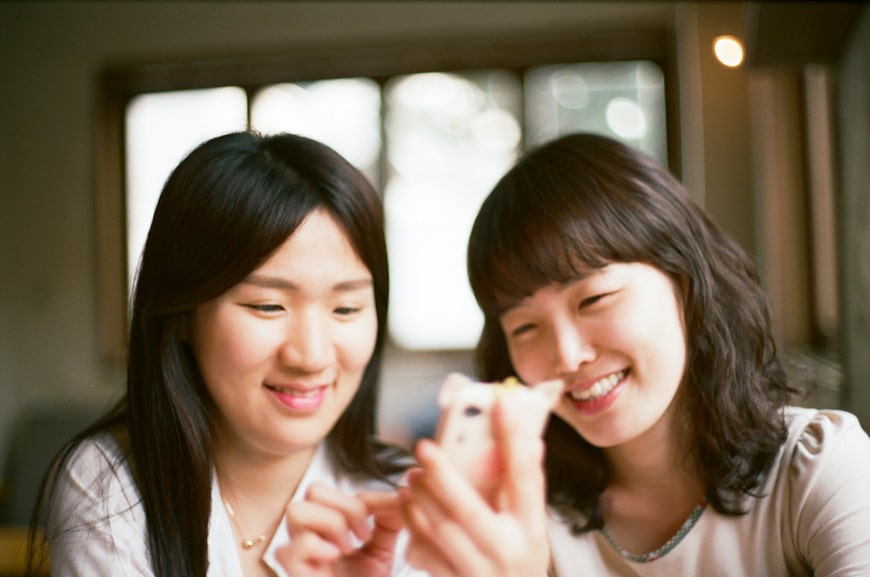 two women using social media on a phone