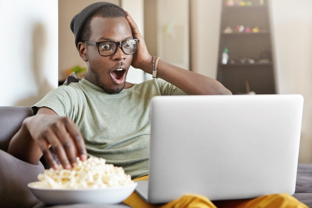 Man enjoying Argentinian shows on his laptop - learn Argentinian slang