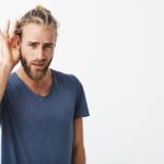 good-looking-swedish-guy-with-beard-cool-hairstyle-holding-hand-near-ear-min-150x150.jpg