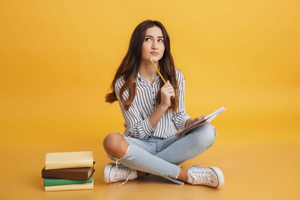 Pensive young woman studying new English words