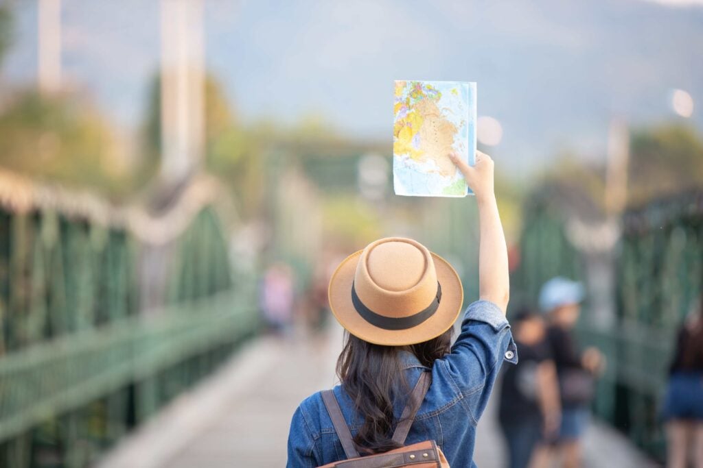 Traveler in the Netherlands using phrases in Dutch and a map to get around