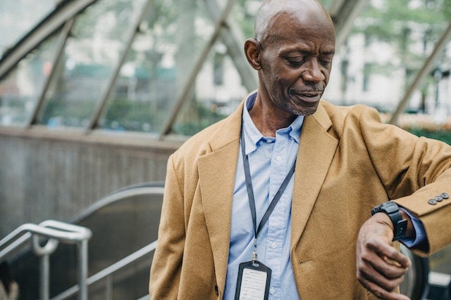 A photo of a man checking the time